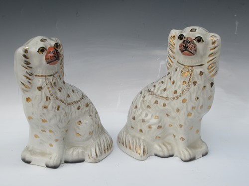 Lot 34 - A pair of Staffordshire spaniels, 24cm high...
