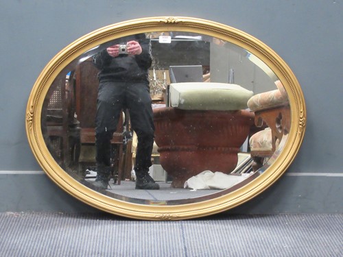 Lot 891 - A circular moulded gilt frame wall mirror with...