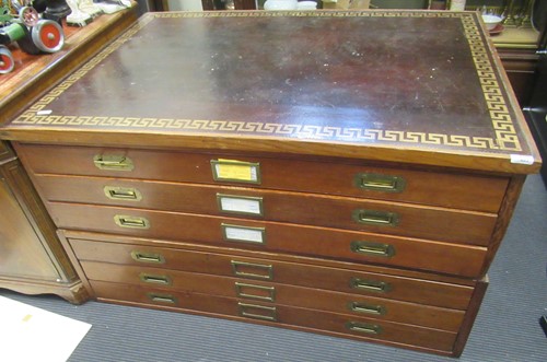 Lot 823 - A plan chest with inset tooled black leather...