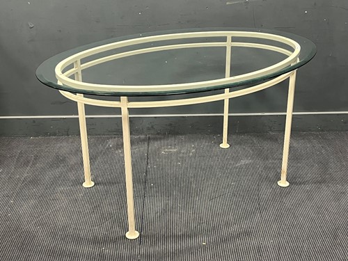 Lot 443 - A painted metal table with oval glass top 76 x...