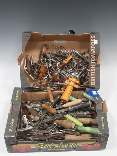 Lot 107 - A box of bygone corkscrews, can openers and...