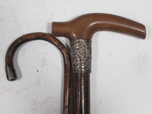 Lot 62 - A silver mounted walking cane, a hardwood...