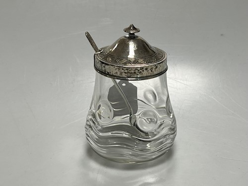 Lot 307 - A silver topped glass conserve jar and spoon,...