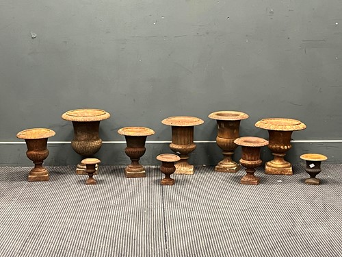 Lot 812 - A group of Victorian cast iron garden urns of...