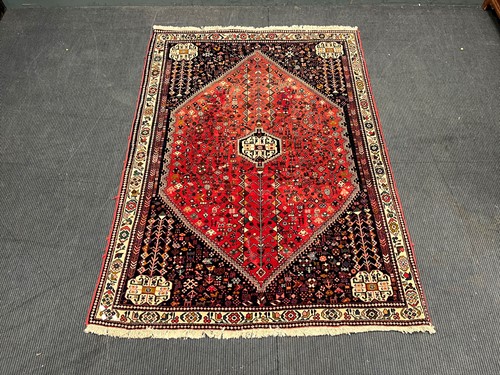 Lot 902 - A Persian design dark blue ground and red...