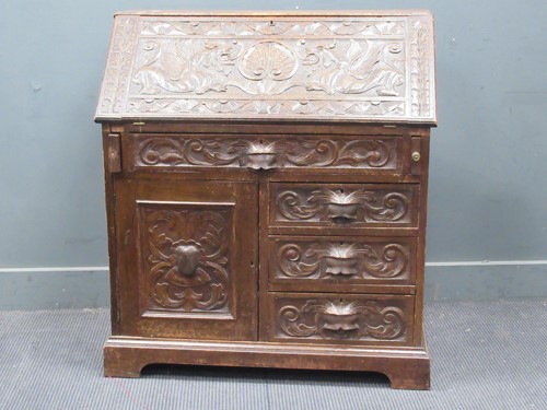 Lot 653 - A late Victorian oak bureau, the fall front...