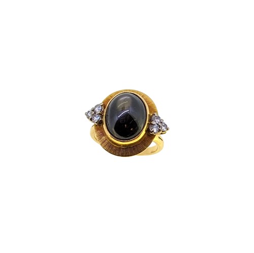 Lot 42 - A late 20th century 18ct gold star sapphire and diamond ring