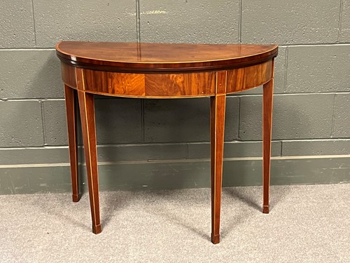 Lot 795 - A mahogany demilune fold over top card table...