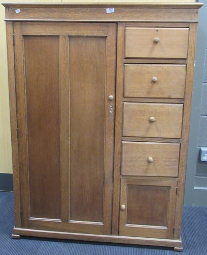 Lot 855 - A 1920s oak bedroom cupboard with door above 4...