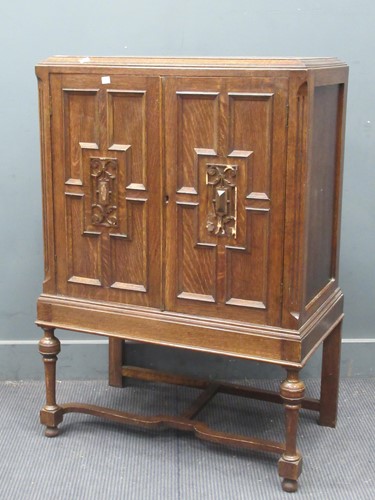 Lot 654 - An oak two door cupboard with geometric...