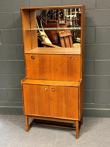 Lot 790 - A 20th century teak drinks cabinet with open...