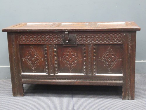 Lot 655 - An 18th century oak panelled coffer chest with...