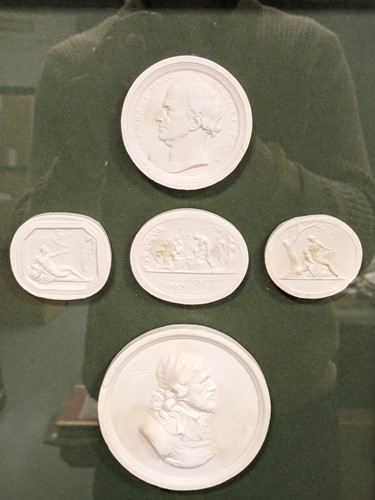 Lot 502 - A modern framed group of five plaster cast...