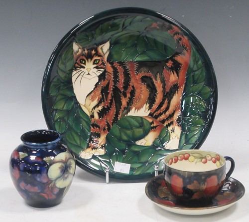 Lot 32 - A Moorcroft cup and saucer, a small vase and...