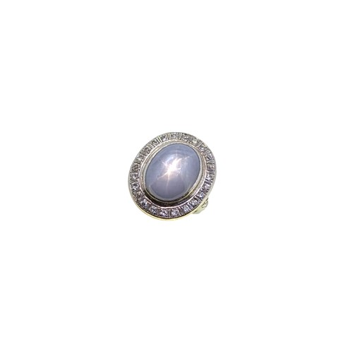 Lot 124 - A star sapphire and diamond cluster ring