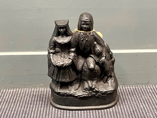 Lot 722 - A cast iron black painted doorstop of a man...