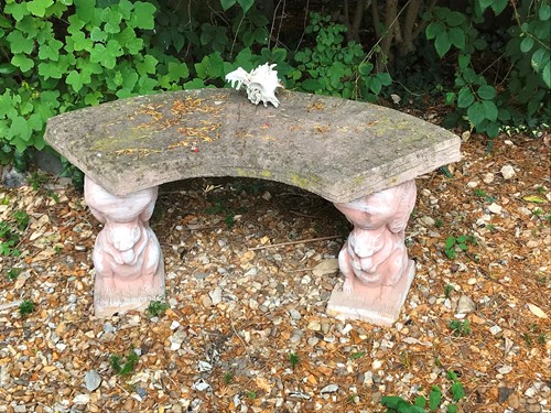 Lot 810 - A composite stone curved garden bench with...