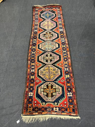 Lot 850 - A Hamadan runner with seven medallions on a...