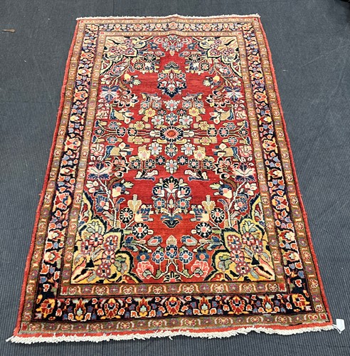 Lot 849 - A red ground Persian style rug 211 x 133cm