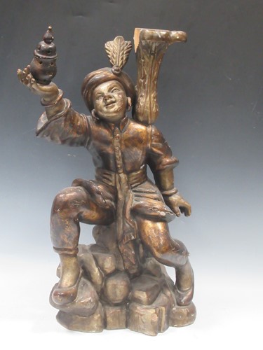 Lot 66 - An Eastern carved wood figure 62cm high