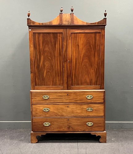 Lot 758 - A Regency mahogany linen press with shaped top...