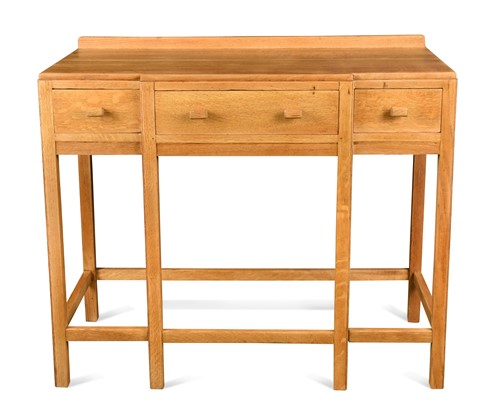 Lot 247 - Attributed to Heal's, a Cotswold School pale oak breakfront side table, circa 1930