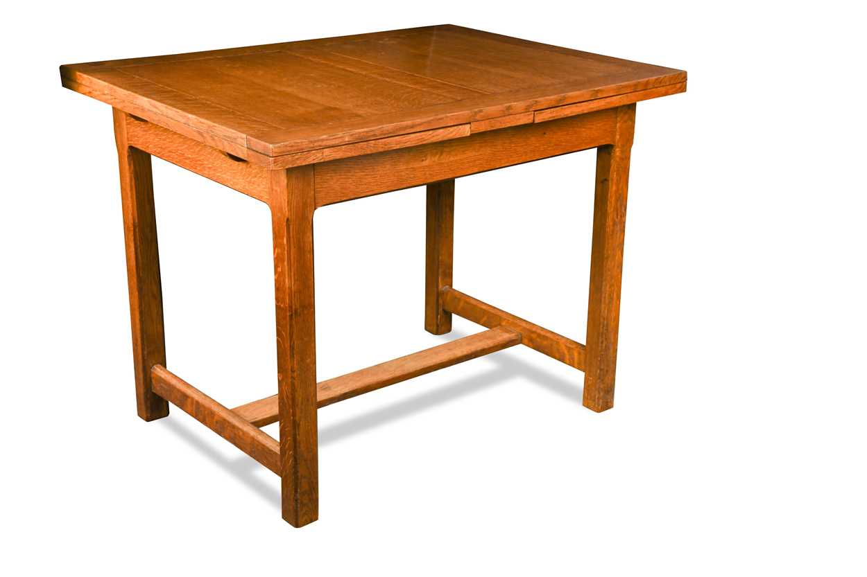 Lot 228 - A Heals oak draw-leaf dining table, circa 1925