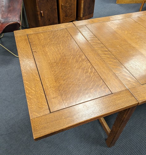 Lot 228 - A Heals oak draw-leaf dining table, circa 1925