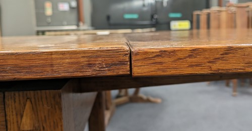 Lot 228 - A Heals oak draw-leaf dining table, circa 1925