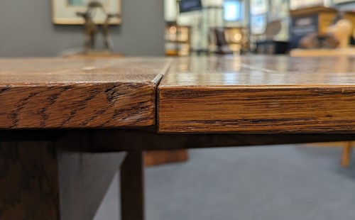 Lot 228 - A Heals oak draw-leaf dining table, circa 1925
