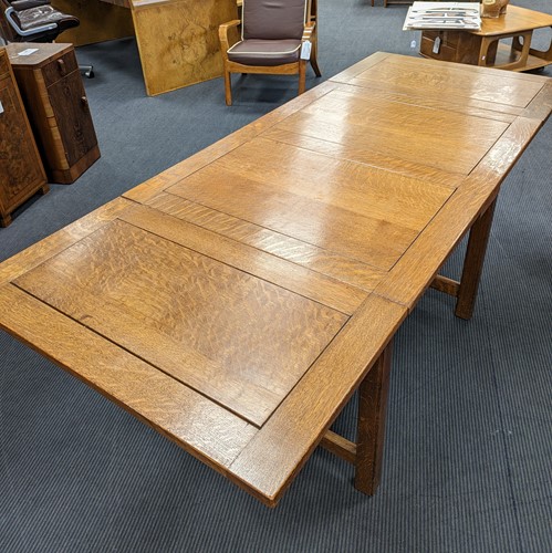 Lot 228 - A Heals oak draw-leaf dining table, circa 1925