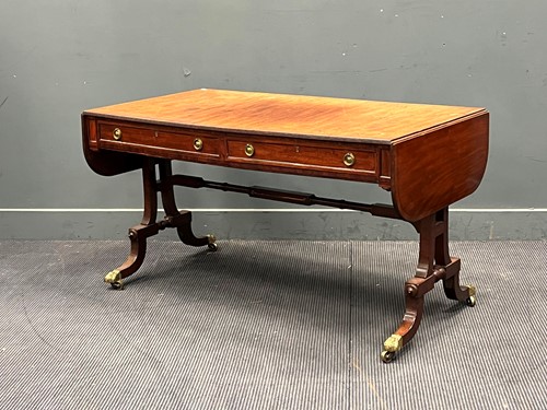 Lot 694 - A late Regency mahogany sofa table on shaped...