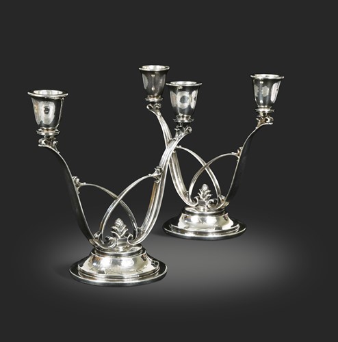 Lot 193 - Harald Nielsen for Georg Jensen, a pair of Danish metalwares twin-branch candelabra