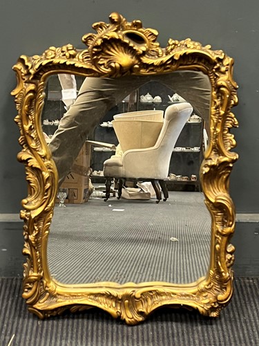 Lot 732 - A Rococo style gilt wall mirror, the frame...