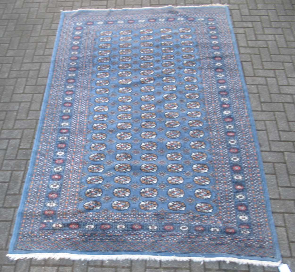 Lot 846 - A modern Teke type rug with slate blue ground...