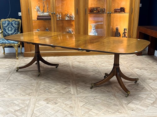 Lot 465 - A Regency style dining table with double...