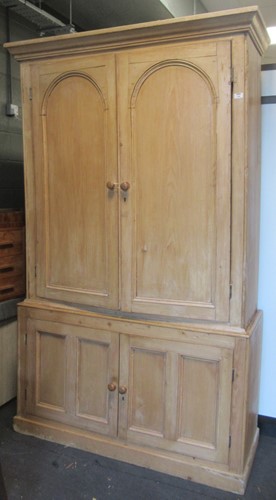 Lot 796 - A Victorian stripped pine wardrobe with arched...