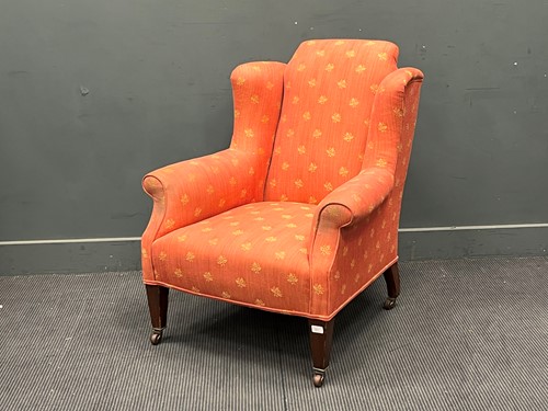 Lot 801 - An Edwardian wing armchair upholstered in rust...