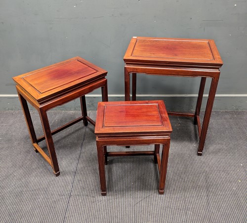 Lot 423 - A Chinese hardwood nest of four tables,...