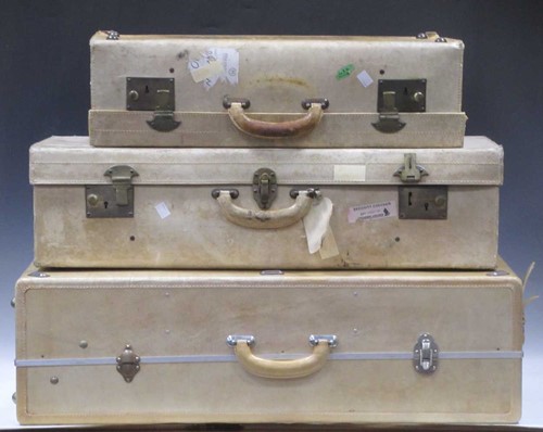 Lot 45 - A graduated pair white hide suitcases. The...