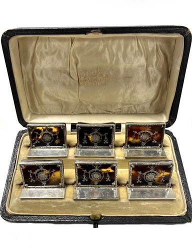 Lot 502 - A cased set of six early 20th century silver and tortoiseshell menu holders