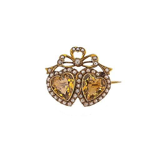 Lot 86 - An Edwardian citrine and split pearl brooch