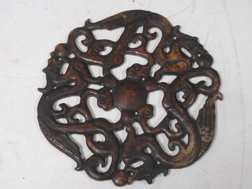 Lot 216 - An oriental circular stone disc decorated in...