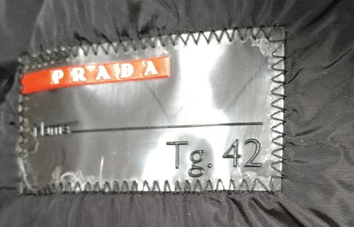Lot 129 - A ladies' Prada coat and three other coats, a...