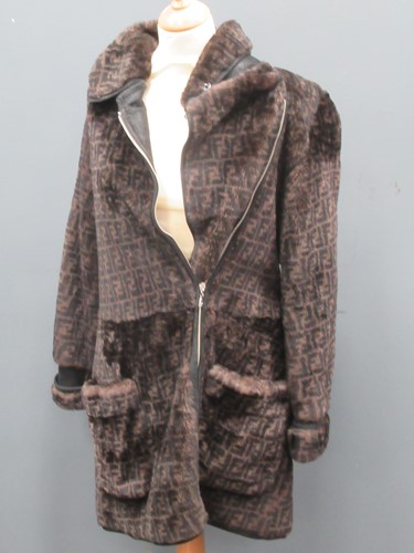 Lot 129 - A ladies' Prada coat and three other coats, a...