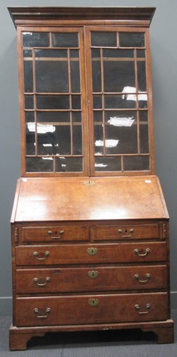 Lot 727 - A Georgian walnut bureau bookcase, the glazed...