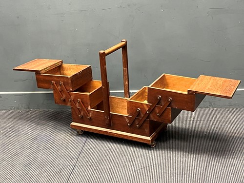 Lot 690 - A mid-century cantilever sewing box with six...