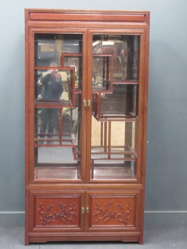 Lot 743 - A Chinese hardwood display cabinet, the lower...
