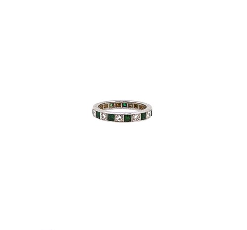 Lot 119 - An emerald and diamond full eternity ring