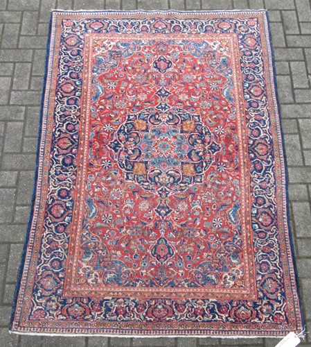Lot 842 - Antique Persian Kashan rug with blue ground...